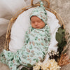 Sleeping baby wrapped in a Snuggle Hunny Kids Daintree Jersey Wrap and Beanie Set