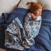 sleeping baby wrapped in a Snuggle Hunny Kids Arizona muslin wrap