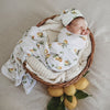Sleeping baby wrapped in a Snuggle Hunny Kids Lemon jersey wrap set