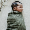 sleeping baby swaddled in a Snuggle Hunny Kids Dusty Olive organic muslin wrap