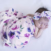 sleeping baby wrapped in a Snuggle Hunny Kids Floral Kiss jersey baby wrap